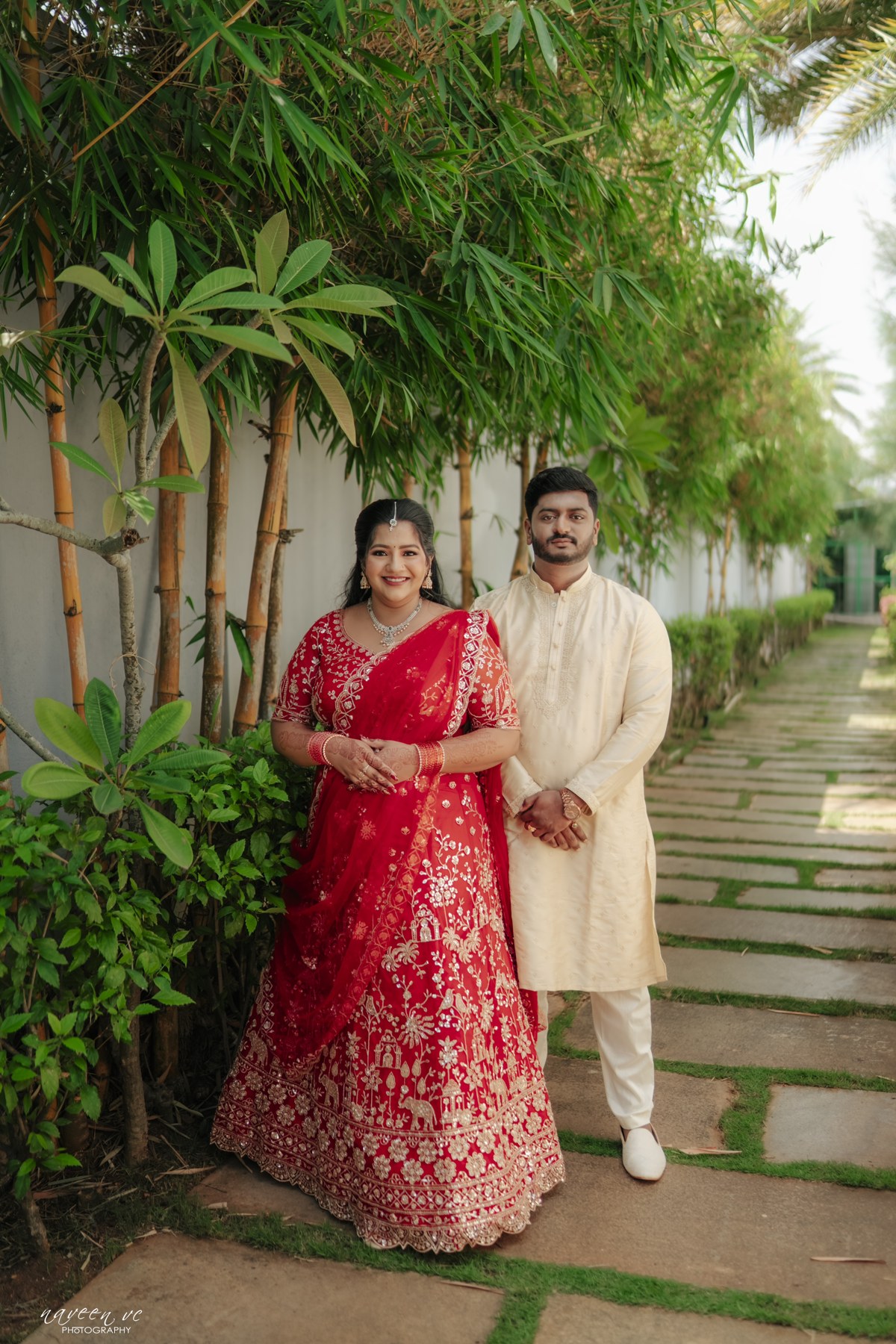Likitha and Prajeeth standing together on a garden path